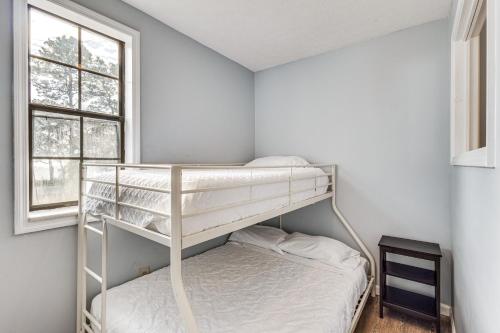 a bedroom with two bunk beds and a window at Steps to Beach Carrabelle Family Home with Patio! in Big Blackjack Landing