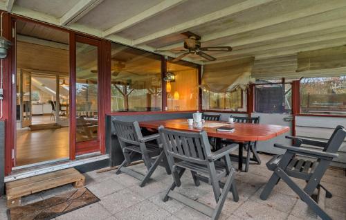 a dining room with a wooden table and chairs at 4 Bedroom Cozy Home In Ans By in Roe