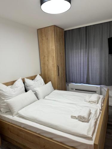 a bedroom with a large bed with white sheets and pillows at SiDi Doppelzimmer 4 in Erfurt
