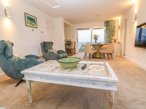 a living room with chairs and a coffee table at Fal View in Falmouth
