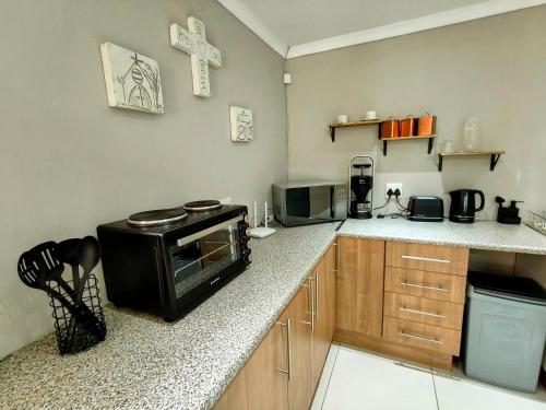 a kitchen with a counter with a stove in it at Harrismith Country Cottage in Harrismith