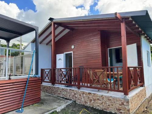 a house being constructed with a large deck at Bungalow cosy près de Basse-Terre - 20 m² avec piscine in Basse-Terre
