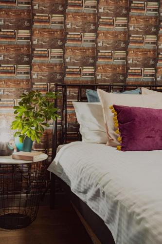 a bedroom with a bed and a wall of books at Jana Apartment in Krakow