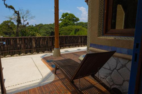 a chair sitting on the porch of a house at El EQUIMITE HOTEL BOUTIQUE in Coatepec