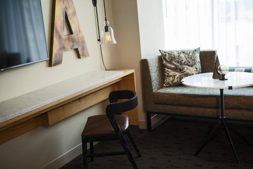 a living room with a chair and a table at Renaissance Allentown Hotel in Allentown