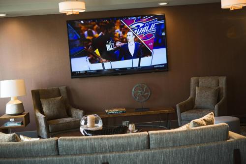 a living room with a couch and a flat screen tv at Renaissance Allentown Hotel in Allentown