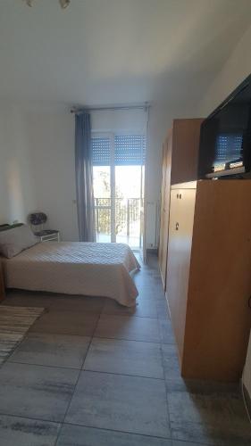 a bedroom with a bed and a flat screen tv at CASA VACANZE Matilde in Gavirate