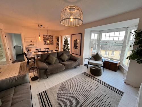 a living room with a couch and a table at A stunning 2 bed apartment in Fishguard