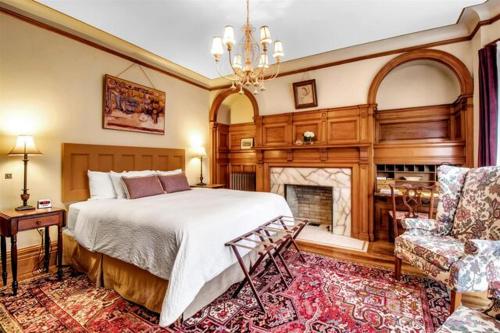a bedroom with a large bed and a fireplace at InnBuffalo Off Elmwood in Buffalo