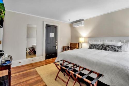 a bedroom with a large bed and two chairs at InnBuffalo Off Elmwood in Buffalo