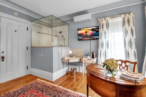 a living room with a table and a window at InnBuffalo Off Elmwood in Buffalo