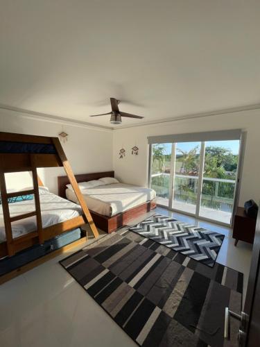 a bedroom with two beds and a ceiling fan at Mareazul Playa del Carmen in Playa del Carmen