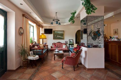 a living room with couches and chairs at Apollon Hotel in Naxos Chora