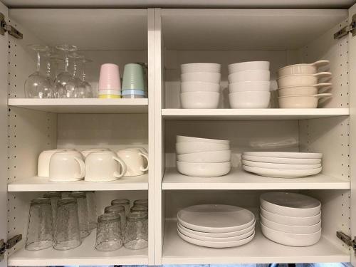 a cabinet filled with plates and bowls and dishes at COZY LOON MOUNTAIN ESCAPE - Free shuttle, Pool, Hot tub, River&Mnt Views in Lincoln