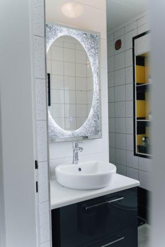 a bathroom with a sink and a mirror at Vista Apartment in Sveta Trojica v Slovenskih Goricah