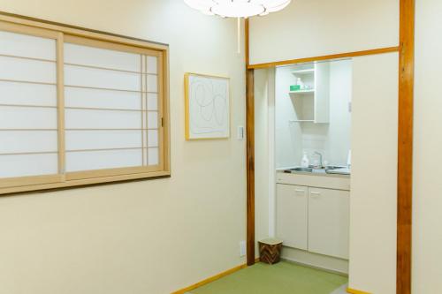 a kitchen with a sliding glass door and a sink at QiQi House Tokyo Hirai Villa 2Bath3WCs 4min Station 24min to Akihabara in Tokyo