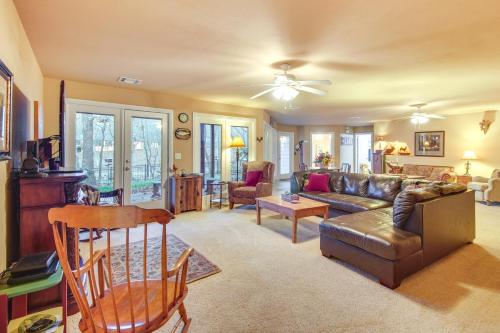 a living room with a couch and a table at Lakefront Home with Furnished Deck in Grove! in Grove