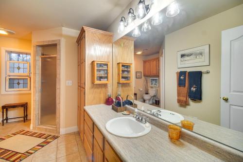 a bathroom with a sink and a shower at Lakefront Home with Furnished Deck in Grove! in Grove