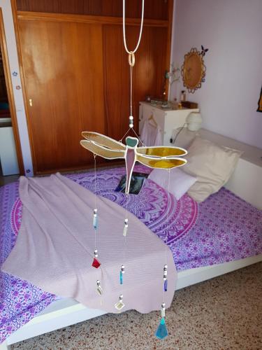 a room with a bed with a fan on it at The Magic Dragonfly in Santa Cruz de Tenerife