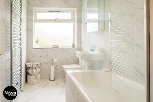 a white bathroom with a sink and a window at Solihull Super Stay NEC, Airport, Parking in Solihull
