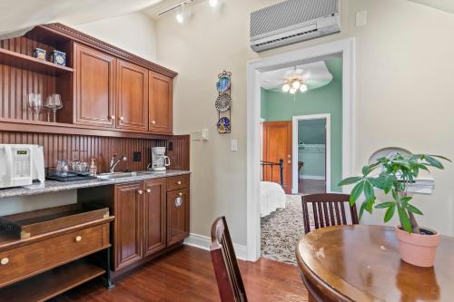 a kitchen with wooden cabinets and a dining table at The Pasfield House in Springfield