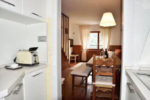 a kitchen and a dining room with a table at Appartamento 1400 - Sulle Piste in Limone Piemonte