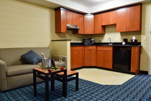 a living room with a couch and a table at Fairfield Inn Hartford Airport in Windsor Locks