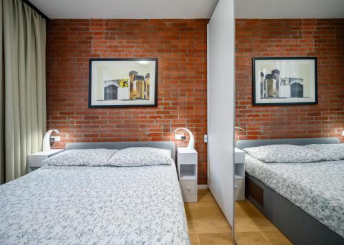 Ένα ή περισσότερα κρεβάτια σε δωμάτιο στο Porta Romana Design Apartment