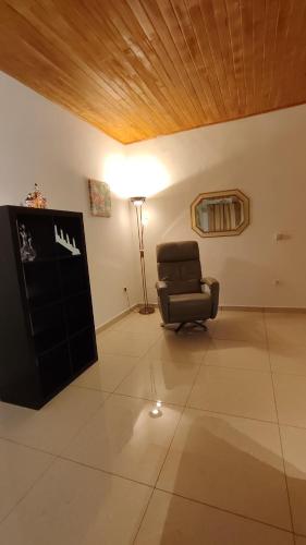 a living room with a chair and a lamp at Résidence Merveilles P14 in Kribi