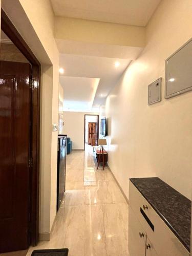 a hallway leading to a kitchen with a counter top at Riviera Sublime Holiday Homes in Siolim