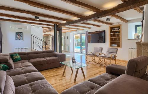 a living room with a couch and a glass table at Villa Simeanna in Kringa