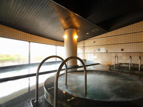a hot tub in a room with a large window at The Paradise Garden Sasebo - Vacation STAY 90006v in Sasebo