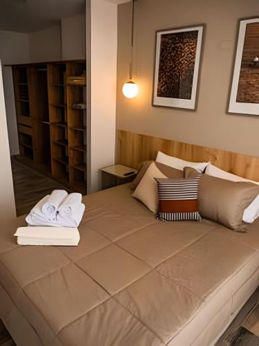 a bedroom with a large bed with two books on it at Torre de Apartasuites Centro Comercial Cerritos Mall in Pereira