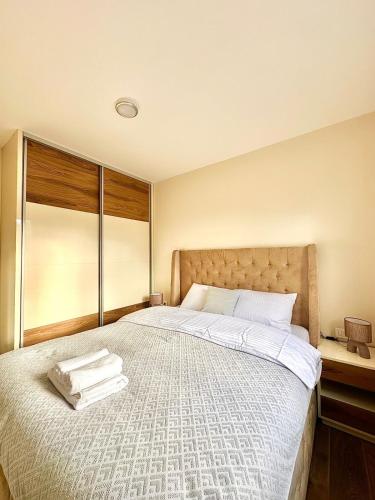 a bedroom with a large bed with towels on it at Pine forest view apartment in Kolašin