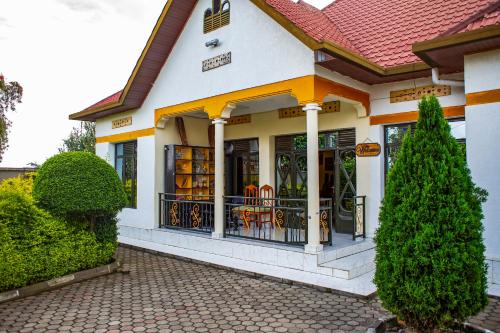 a house with a porch with a gate at Virunga Homestays in Ruhengeri