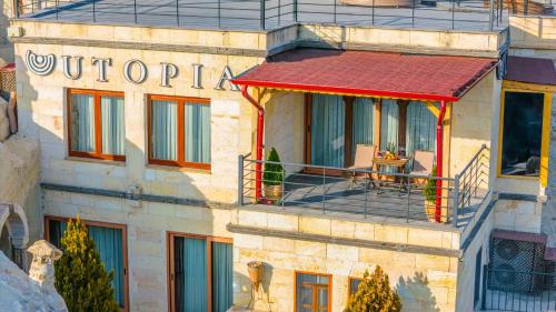 a building with a sign on the side of it at Utopia Cave Cappadocia in Urgup