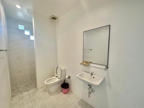 a bathroom with a sink and a toilet and a mirror at Kohchang stayin premium hotel in beach street market in Ko Chang