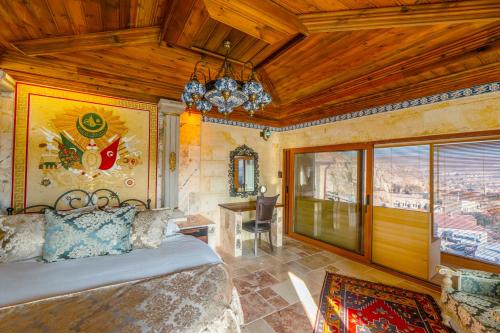 a bedroom with a bed and a chandelier at Utopia Cave Cappadocia in Urgup