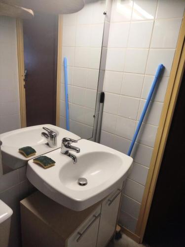 - un lavabo blanc dans la salle de bains pourvue de tuyaux bleus dans l'établissement Résidence Le Tourmalet - maeva Home - Studio 4 personnes - Confort MAE-8121, à La Mongie