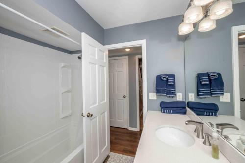 a bathroom with a sink and a tub and a mirror at Peaceful Dove in Tylersville