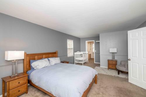 a bedroom with a bed and a crib in it at Peaceful Dove in Tylersville