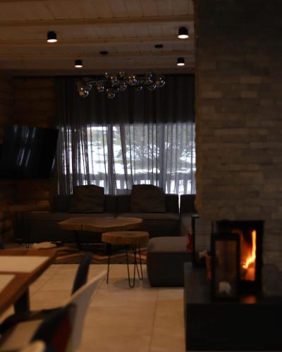 a living room with a couch and a fireplace at Маєток Ліс і Гори in Bukovel