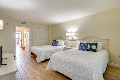 a bedroom with two beds and a living room at 1 Mi to Myrtle Beach Boardwalk Oceanfront Condo in Myrtle Beach