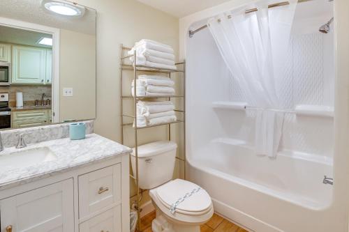 a bathroom with a toilet and a sink and a shower at 1 Mi to Myrtle Beach Boardwalk Oceanfront Condo in Myrtle Beach