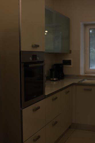 a kitchen with a stove top oven next to a window at Маєток Ліс і Гори in Bukovel