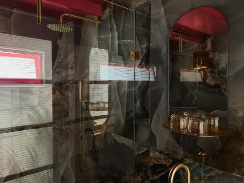 a bathroom with a shower with a glass door at Stay Classy - Domes in Otterlo