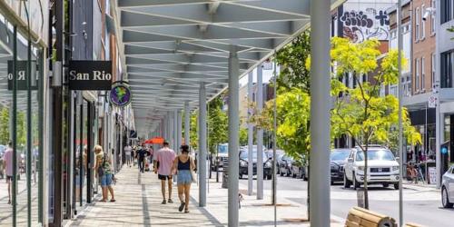 a group of people walking down a sidewalk on a city street at Huge 3 Bedroom Condo with a Large Patio in Montréal