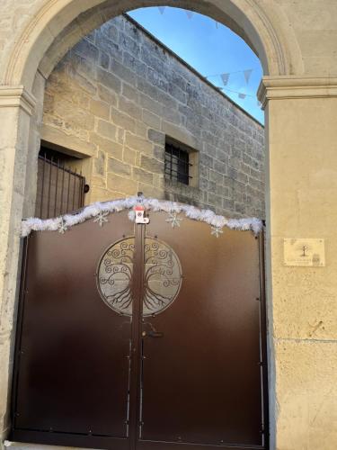 a large brown door with snow on top of it at CASE VACANZA ZOE - LUNA in Serrano