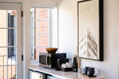 a kitchen with a counter with a microwave and a window at The VanderMarck Boutique Hotel in Collingwood