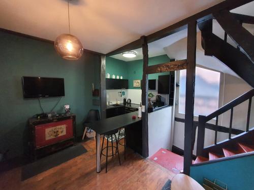 sala de estar con escalera y cocina con mesa en Appartement typique Rouen centre tout confort, en Rouen